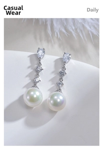 Macro shot of S925 silver pearl drop earrings with clear cubic zirconia stones