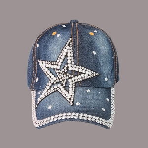 Detail of blue denim baseball cap with rhinestone star and pearl embellishments