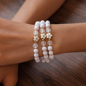 Three-piece acrylic beaded bracelets set with elegant white enamel flower charms