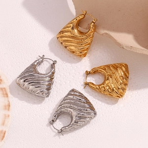 Detailed view of 18K gold and silver plated wavy texture hollow trapezoid earrings