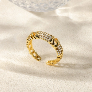 Detailed macro of gold plated adjustable ring with micropave zircon and twisted band