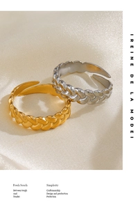 Detailed macro view of twisted rope braided rings in gold and silver finish on white silk