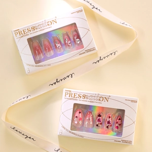 Pink gradient press-on nails with heart gemstones and silver glitter in a gift box