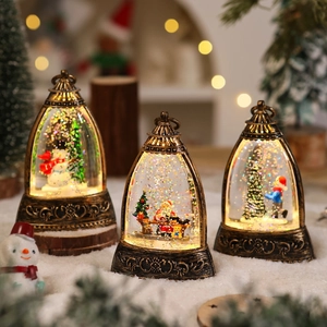 Detail of retro bronze Christmas water lanterns with Santa and LED glitter snow effects
