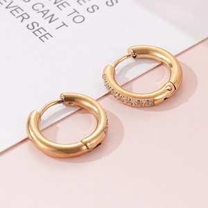 Close-up of 18K gold plated hoop earrings with pave cubic zirconia and hinge closure