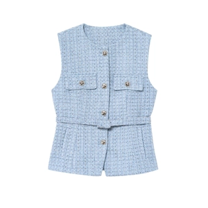 Detailed texture of light blue tweed vest featuring elegant silver metal buttons