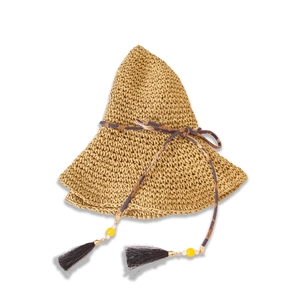 Detailed macro view of khaki straw hat featuring leopard print ribbon and black fringe tassels