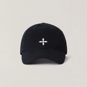 Close-up of a black cotton baseball cap featuring a white embroidered star emblem on front