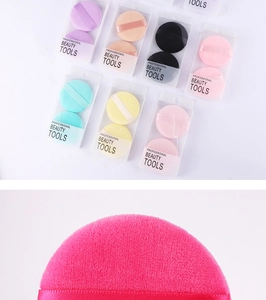 Detail view of colorful soft velvet powder puffs in two-piece sets with satin ribbons