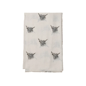 Detailed view of highland cow prints on a soft beige winter scarf with fringe edges