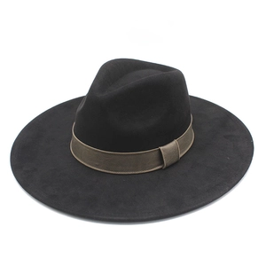 Close-up of black wool fedora featuring a dark brown ribbed ribbon with buckle detail