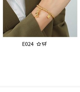 Detail of 18K gold plated bracelet with bunny and rectangular pendant on female model
