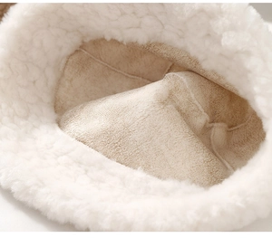 Detailed macro view of the soft faux shearling lining and warm suede interior of the hat
