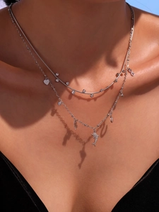 Detail of silver dolphin pendant necklace with cubic zirconia on a female model