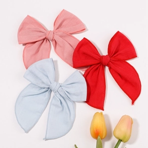 Detailed set of large cotton linen hair bows in pink, red, and blue colors