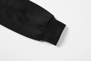 Detailed macro shot of ribbed cuffs on a black athletic sweatshirt for women