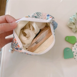 Inside view of floral cotton mini pouch showing storage capacity for small items