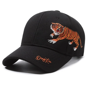 Black cotton baseball cap with detailed tiger embroidery and side signature on white background
