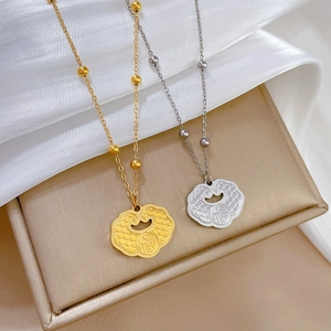 Titanium steel necklaces featuring Fu character lock pendants in gold and silver finishes