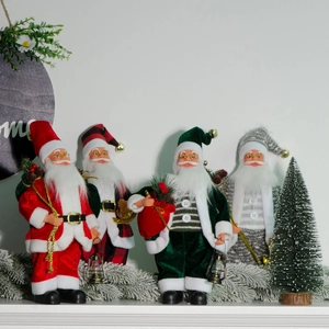 Detailed view of four standing Santa Claus figurines with lanterns and gift bags