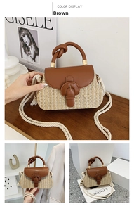 Detail of straw handbag with brown leather flap and stylish knotted handle