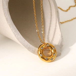 18K gold hollow ring pendant necklace with zircon crystals on a minimalist background