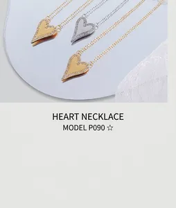 Detailed view of silver and gold heart pendants with shimmering pavé crystal edges