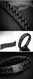 Macro detail of matte black stainless steel Cuban chain bracelet with industrial buckle