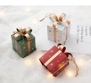 Three-piece mini Christmas gift box ornaments in red, green, and white with golden bows