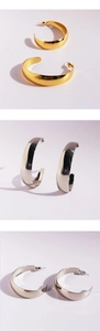 Detailed views of polished gold and silver hoop earrings with high mirror finish