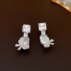 Close-up of silver earrings featuring square cubic zirconia and micro-pave floral details
