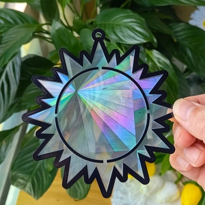 Close-up of star-shaped rainbow suncatcher with holographic laser reflection for window decor