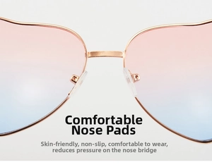 Detail of heart sunglasses featuring golden metal bridge and soft silicone nose pads