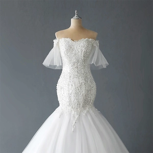 Elegant off-shoulder mermaid wedding dress with lace embroidery and bell sleeves