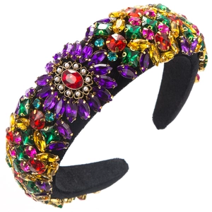 Close-up of luxury velvet headband with colorful rhinestones and white pearls