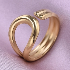 Macro shot of minimalist gold adjustable open ring with irregular organic wave design