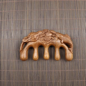 Sandalwood meridian massage comb with hand-carved koi and lotus design on top