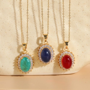 Detailed view of three 14K gold plated necklaces with green, blue, and red zircon pendants