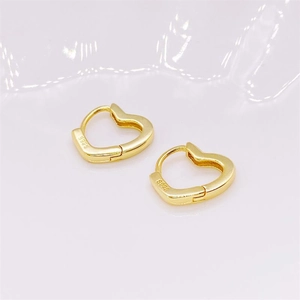 Close-up of golden S925 sterling silver hollow heart hoop earrings with hallmark engraving