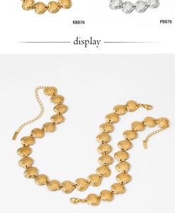 Detailed macro view of gold and silver seashell pendants with lobster clasp and chain