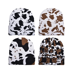 Winter knitted beanie hats with cow print patterns in four different color options