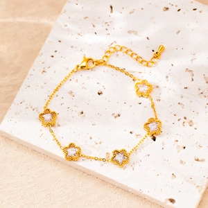 Detailed macro view of gold-plated star charms with zircons and beaded edge on O-chain