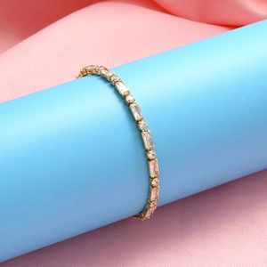Adjustable golden bracelet featuring square and round zircons on blue display stand