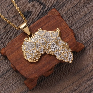 Golden Africa map pendant necklace with rhinestones and twist chain on dark wood base