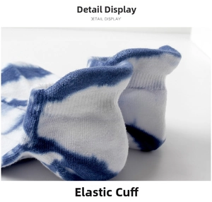 Detailed macro view of the elastic ribbed cuff on blue and white tie-dye cotton socks
