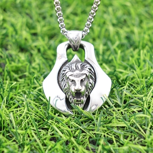 Macro detail of silver lion head pendant with intricate mane on a bead chain necklace