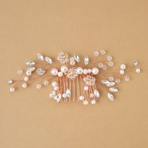 Rose gold bridal hair comb with elegant white pearls and crystals for wedding hairstyles