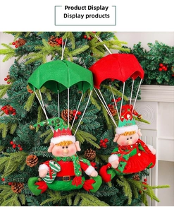 Plush Christmas elves with colorful parachutes hanging on a festive tree with berries
