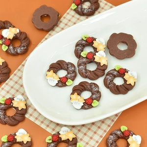 Miniature chocolate Christmas wreath donuts with star frosting on a white oval plate