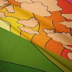 Detail of bohemian rainbow tapestry fabric showing soft felt texture and sun cloud patterns
